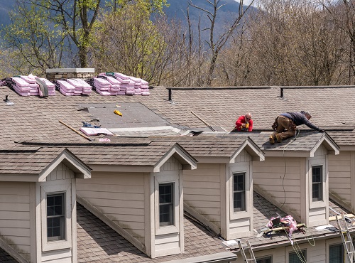 Champaign Roofing Companies repairing a roof