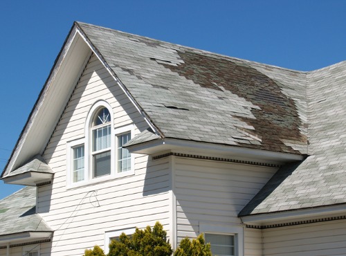 A damaged roof requiring Roof Replacement in Bloomington IL