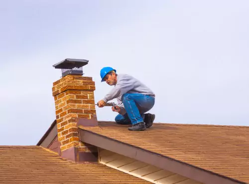 A roofer is seen at work. Call Popejoy Roofing if you need Roofing in Bloomington IL.