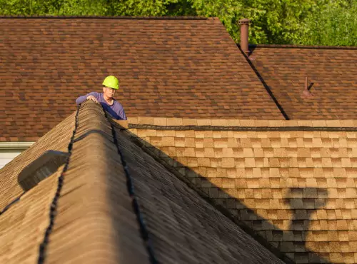 A roofer is seen at work. Call Popejoy Roofing if you need Roofing in Bloomington IL.