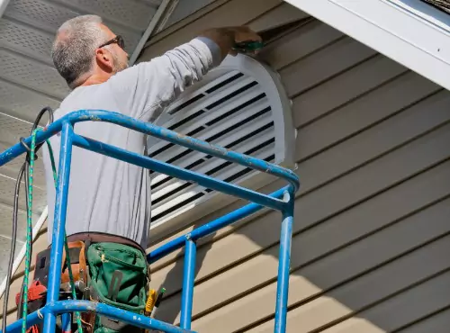 A siding contractor is seen at work. Popejoy Roofing is one of the top siding companies in central IL.