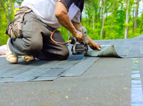 A member of Popejoy Roofing repairs a Hail Damaged Roof in Fairbury IL