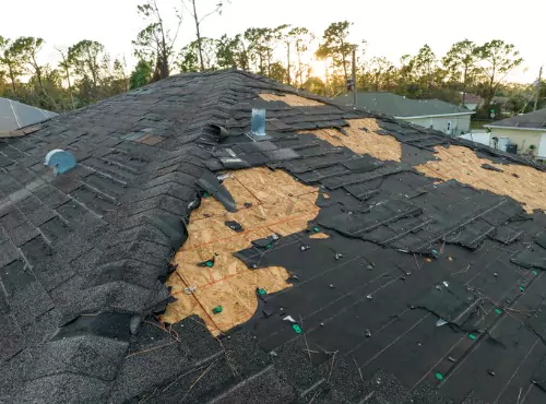 A damaged roof is seen. Popejoy Roofing offers repairs for Roof Damage in Monticello IL.